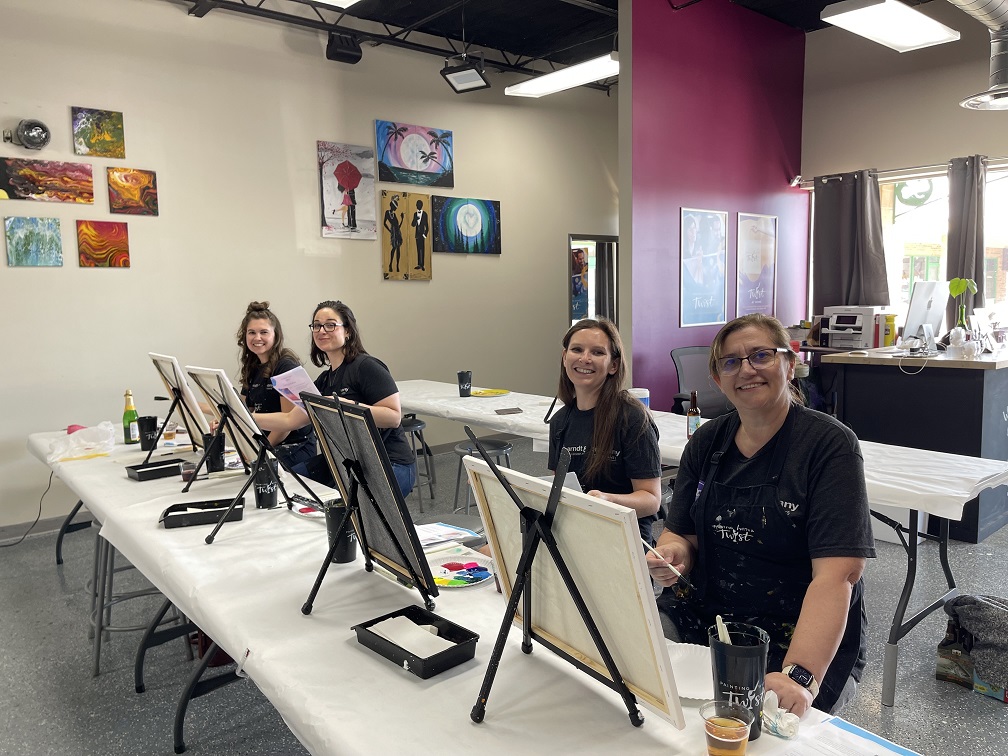 Enjoying team building at Painting with a Twist!